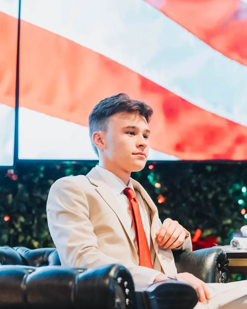 Nico Delgado in front of an American flag